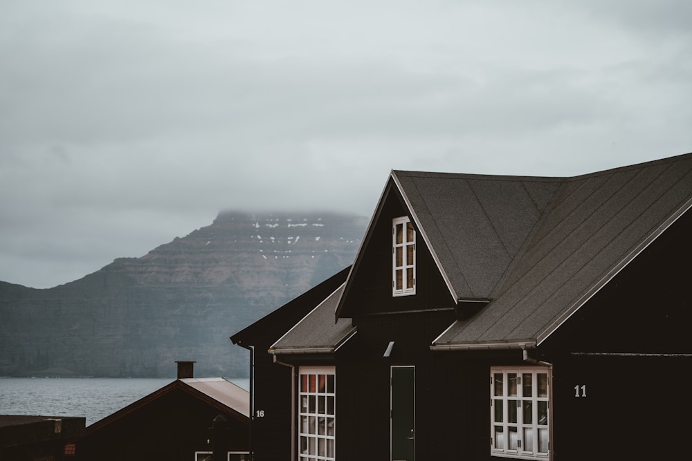 black house near body of water