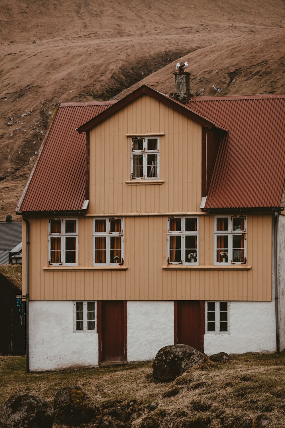 brown and white house on brown mountain