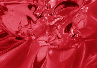 Abstract deep crimson red geometric shape with bright red liquid accents symbolizing energy and movement.