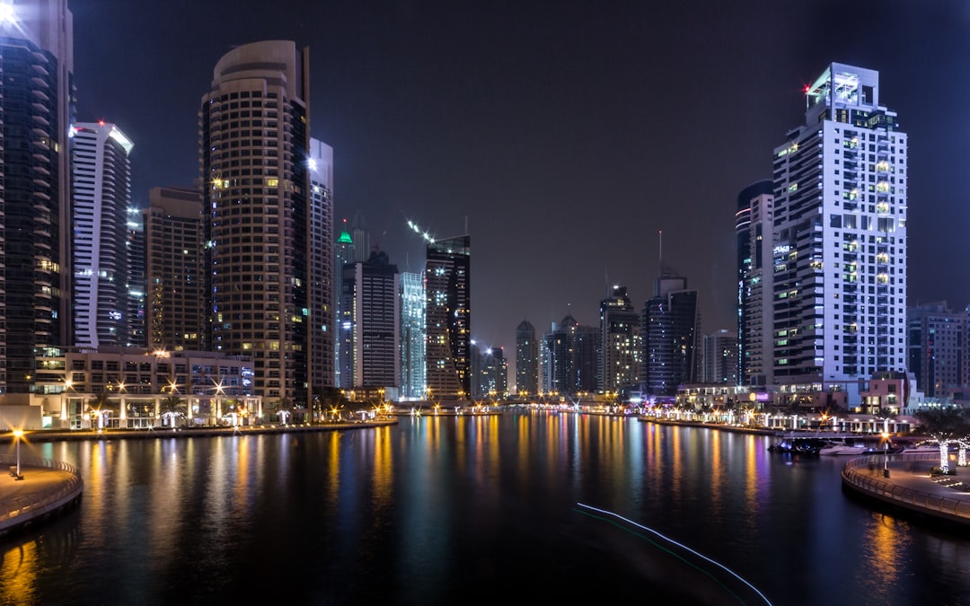lighted city buildings beside body of water, Dubai Marina