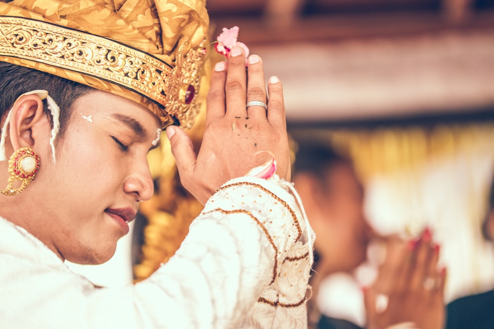 man wearing coat while praying