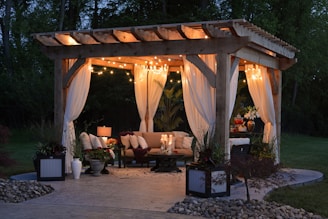 photo of gazebo with curtain and string lights