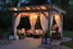 photo of gazebo with curtain and string lights