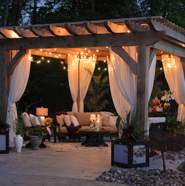 photo of gazebo with curtain and string lights