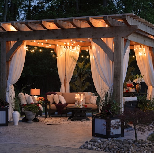 photo of gazebo with curtain and string lights