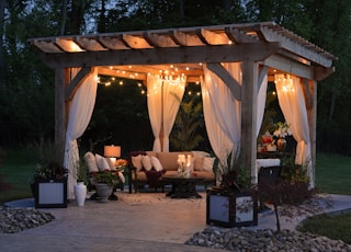 photo of gazebo with curtain and string lights