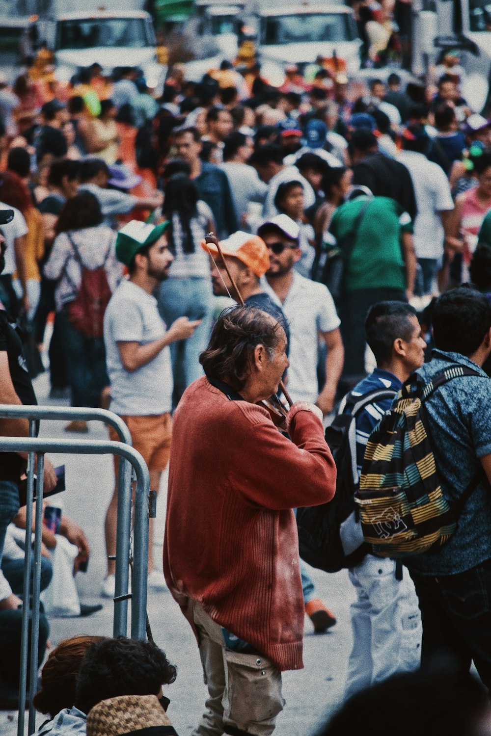 man playing violin in a crowded place