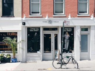 black bicycle leaning on street post
