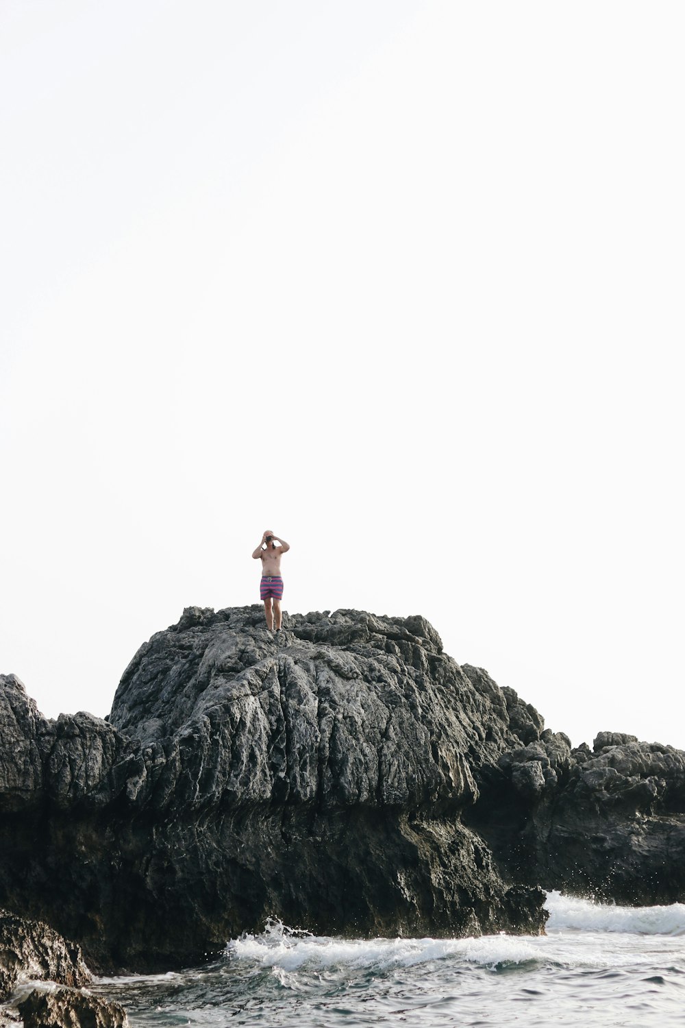 man on top of rock formation