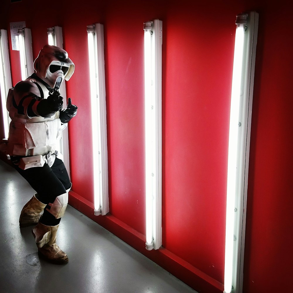 person wearing gas mask near fluorescent lamp