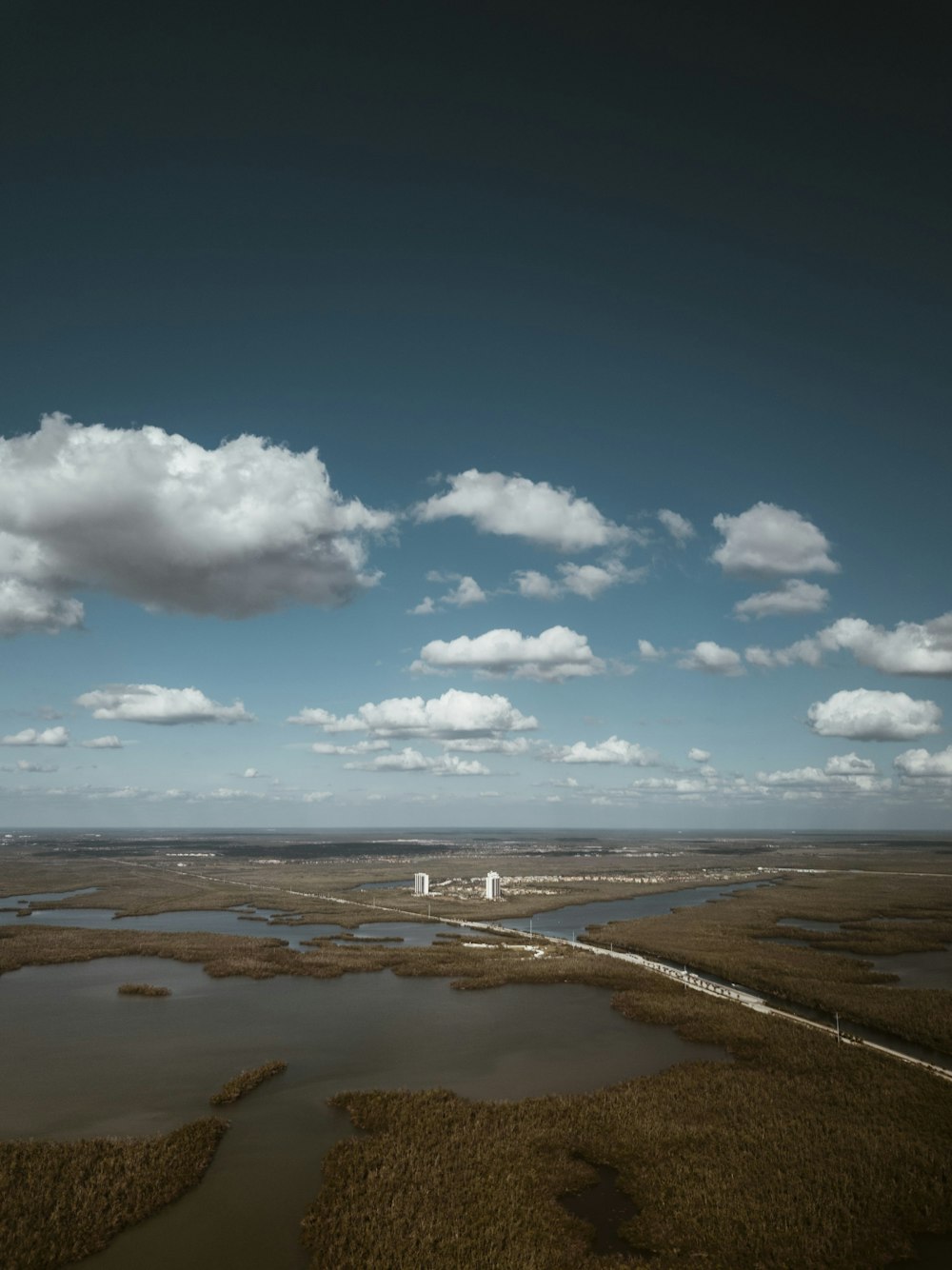 aerial view of body of water under gray sky during daytime