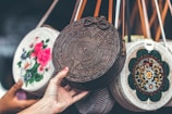 person holding brown sling bag