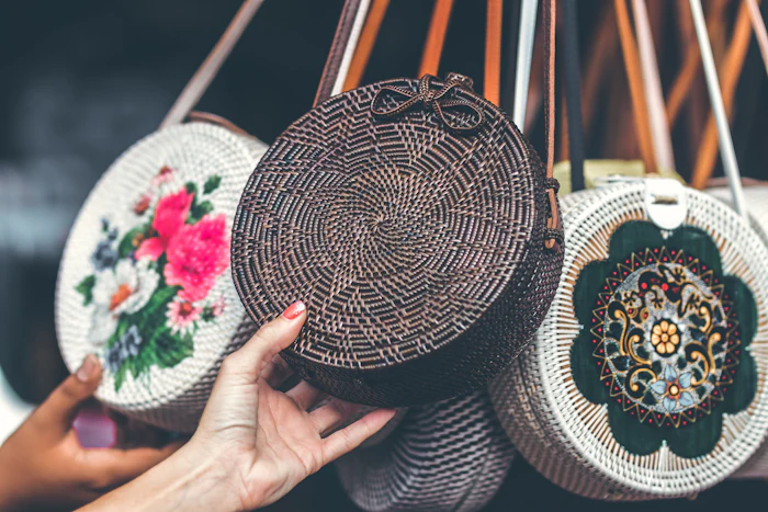 Hemp and leather bags arranged on a linen surface