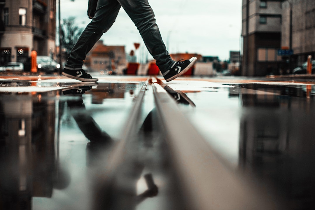 person walking in wet road