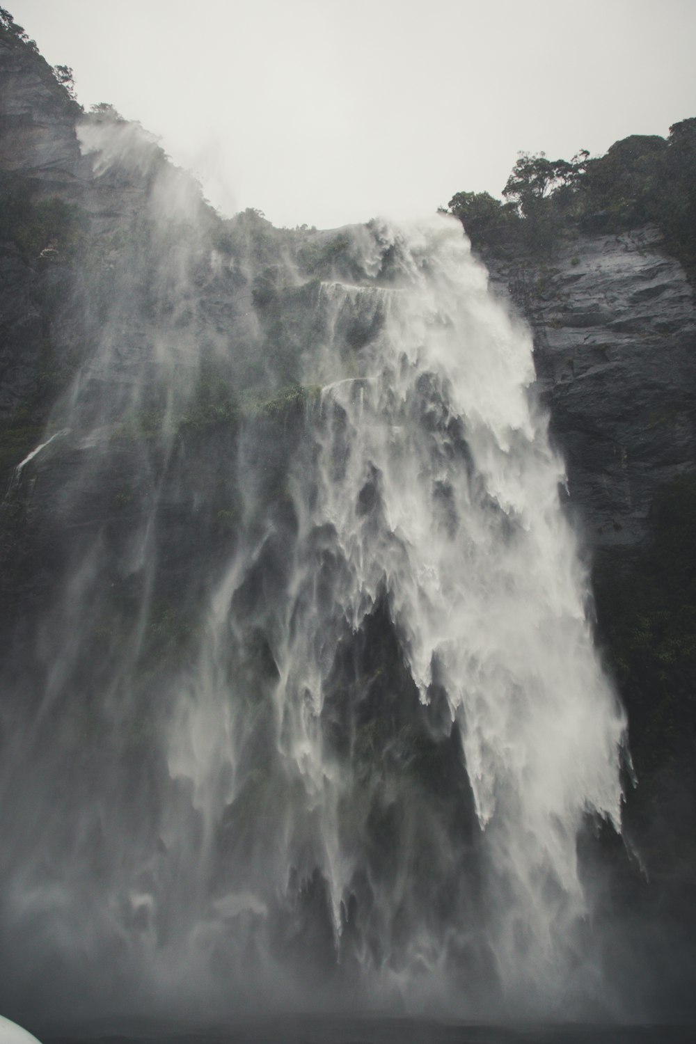 water falls on black and white mountain