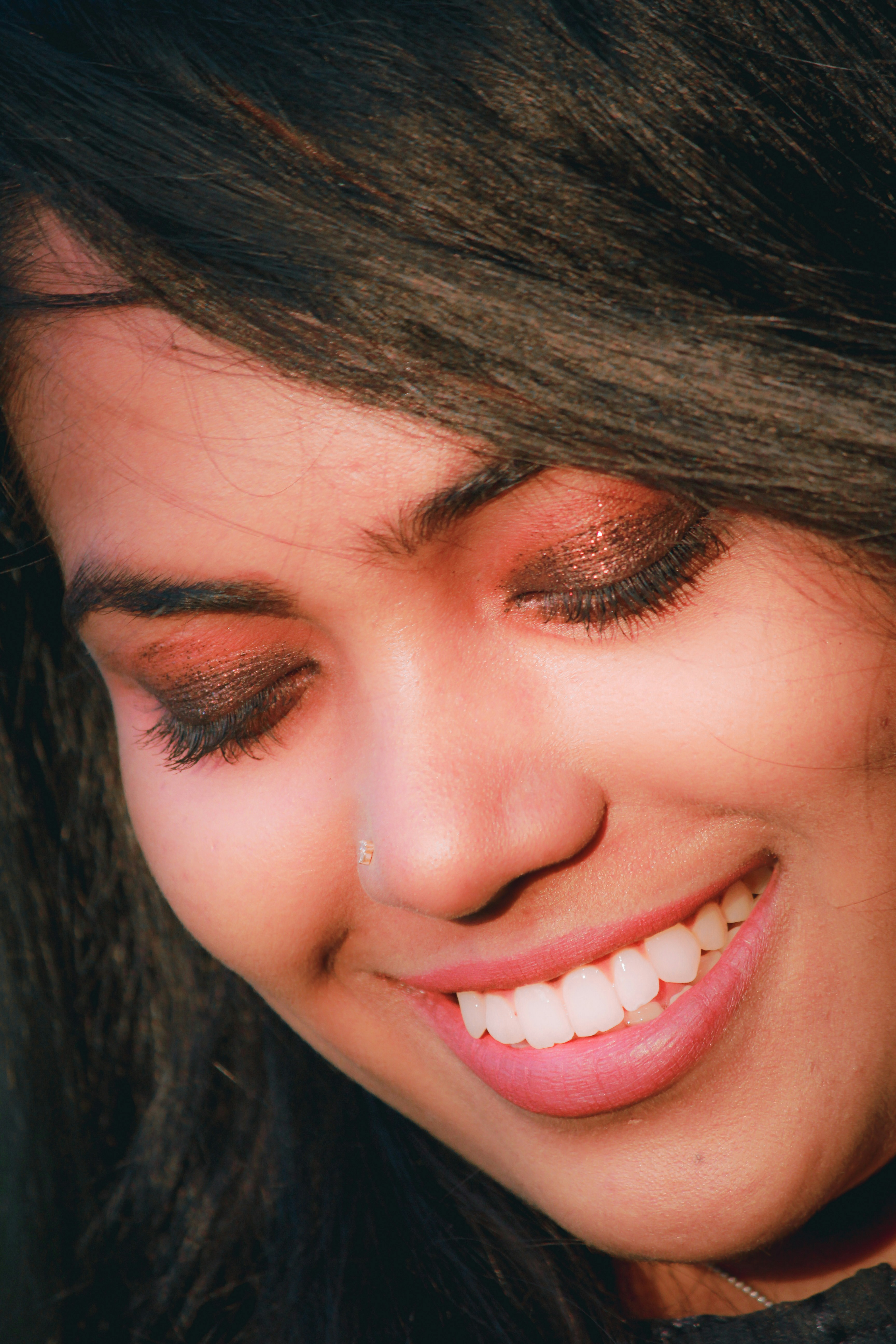 Young woman with a confident smile showing white teeth