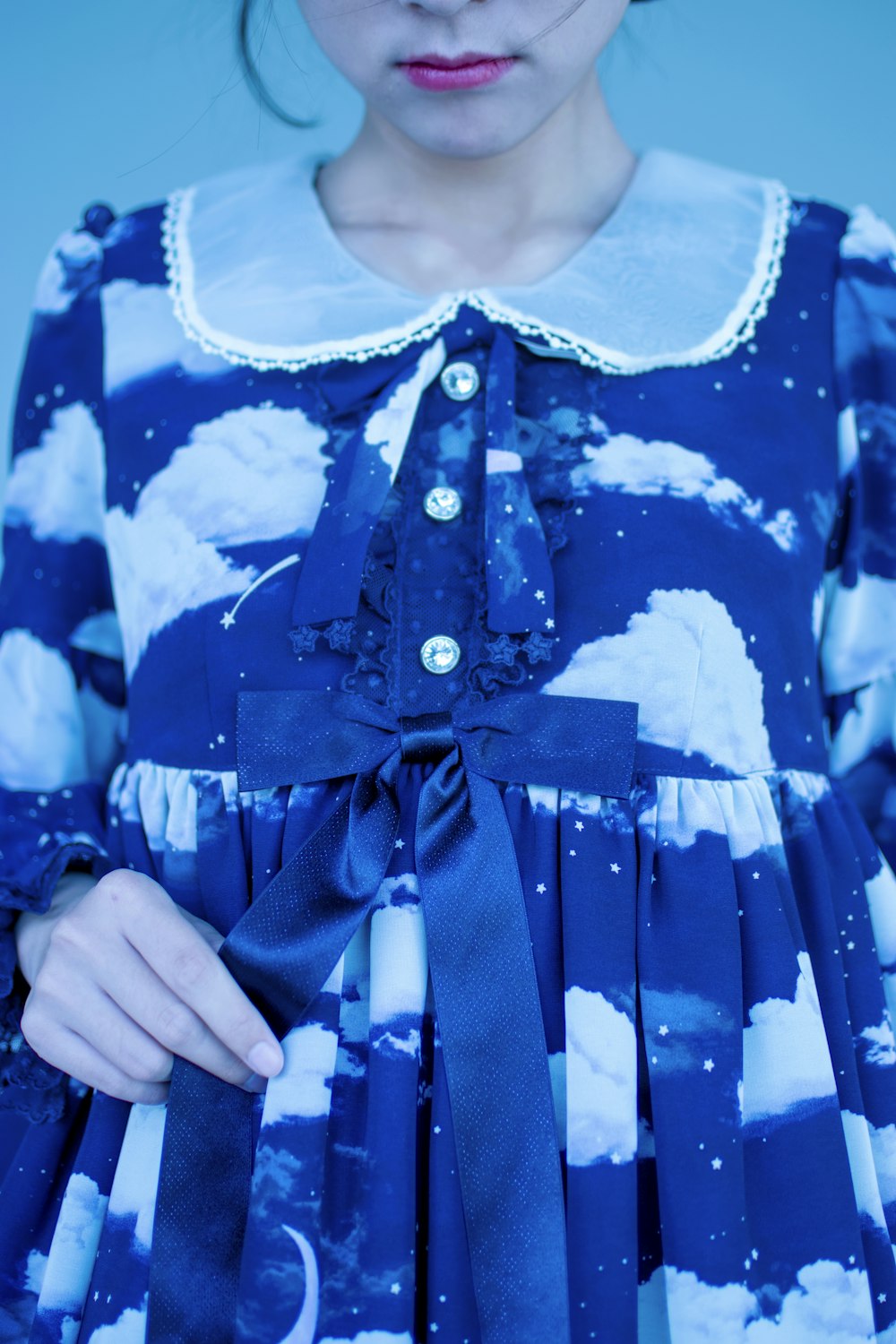 photo en gros plan d’une femme en robe à manches longues à col bleu et blanc