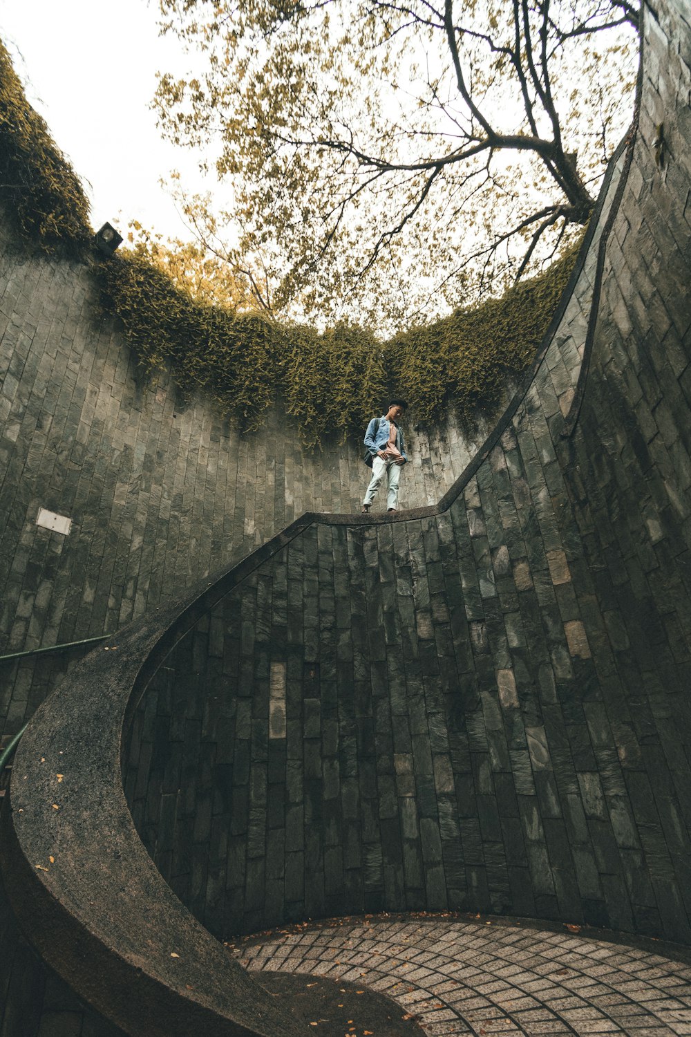 man inside artificial hole with stair