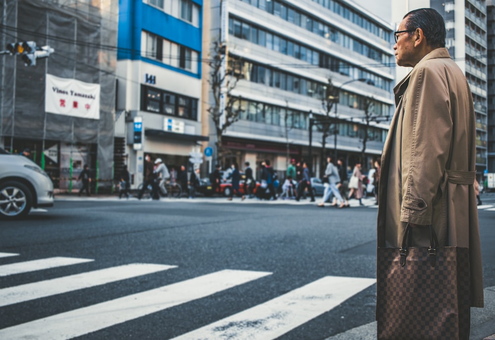 man standing in front of concrete buildings