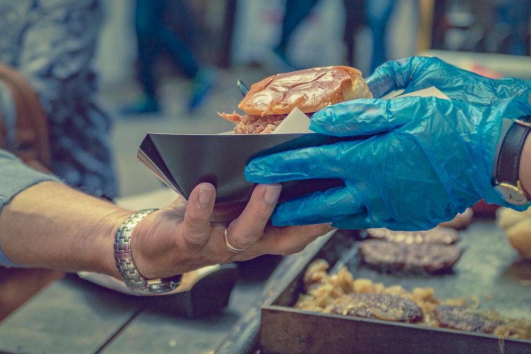 person giving burger to person