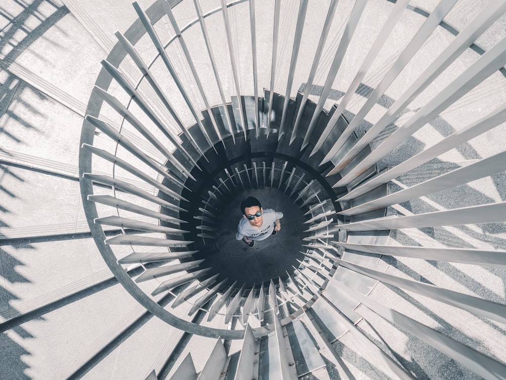 a man standing in the middle of a spiral staircase