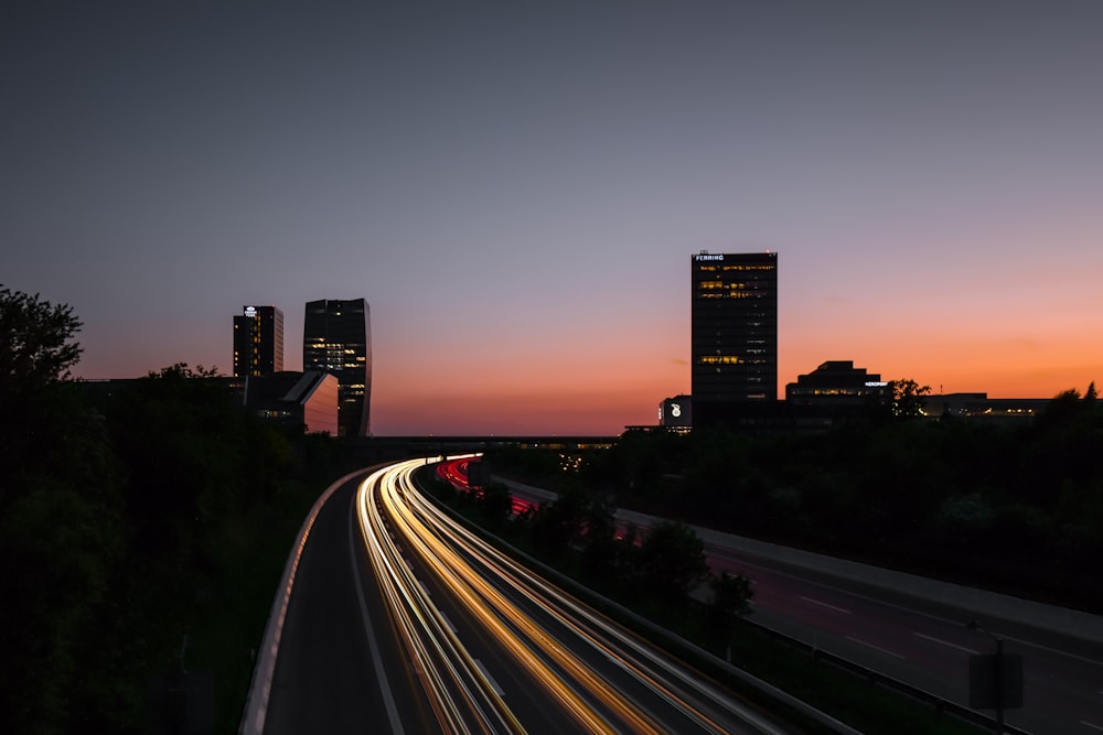 time lapse photo of vehicle passing on road