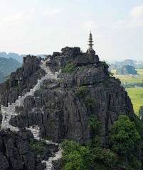 brown and white pagoda on top of brown mountain during daytime