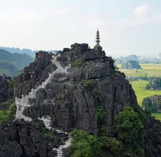 brown and white pagoda on top of brown mountain during daytime