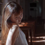 Model wearing a custom Sunday’s Blest polo shirt standing in a softly lit church hallway.