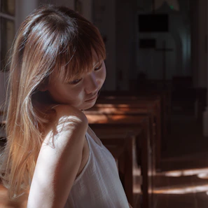 Model wearing a custom Sunday’s Blest polo shirt standing in a softly lit church hallway.