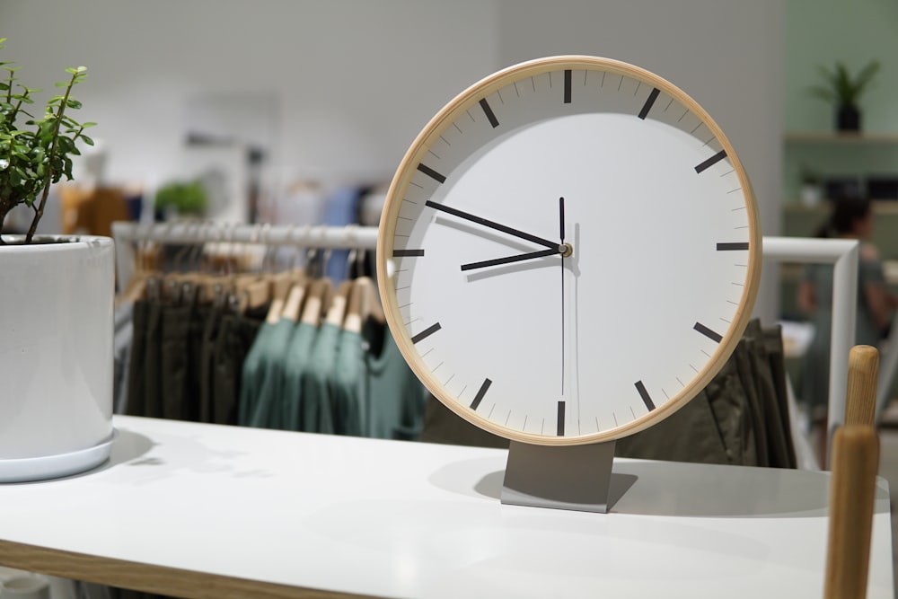 brown and white wall clock displaying 8:44