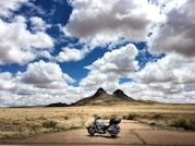 parked touring motorcycle under blue sky during daytime