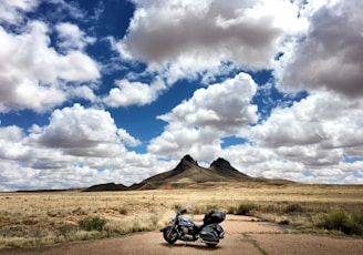 parked touring motorcycle under blue sky during daytime