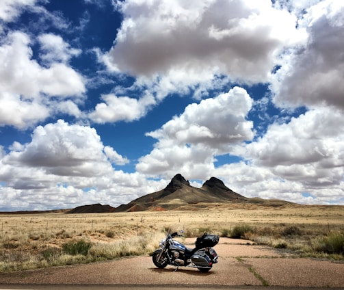 parked touring motorcycle under blue sky during daytime