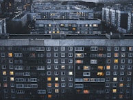 Evening scene showing warm lights glowing from the windows of a multi-unit modular complex.