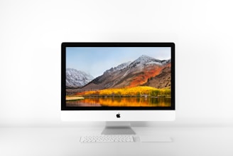 silver iMac and Magic keyboard on white surface