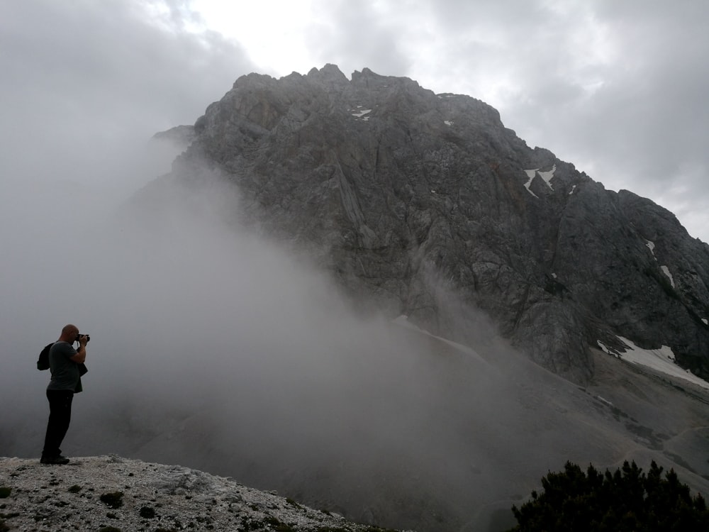 man taking photo at mountain during daytyime