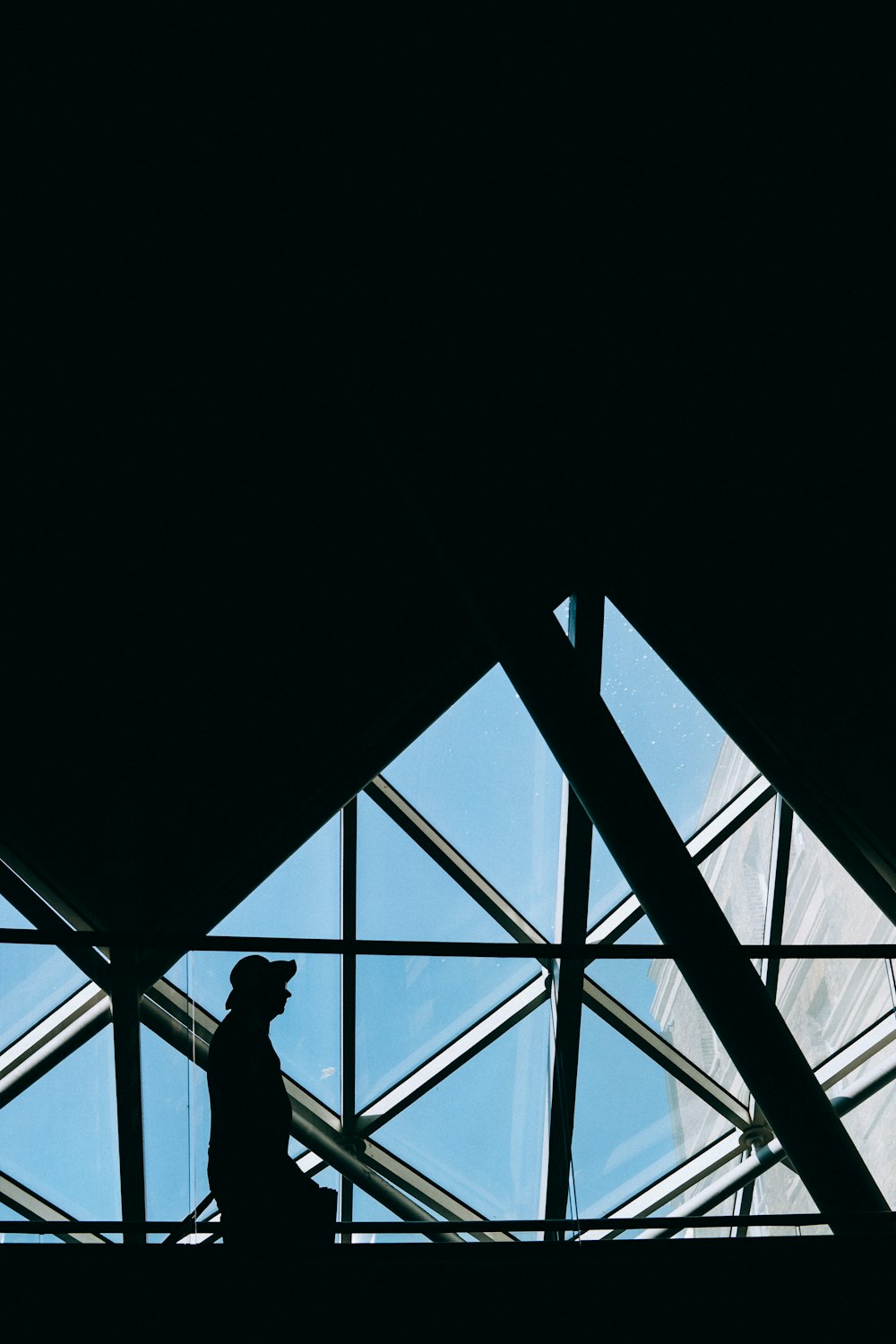 low light photography of person walking near window