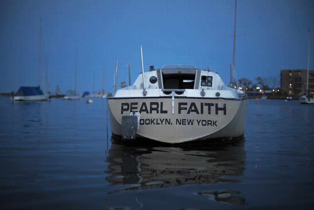 white speed boat on bod of water