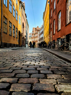 low angle view photography of street and parked bikes
