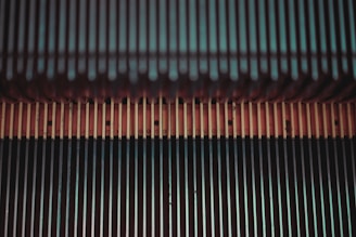 A technician repairing an escalator with tools and equipment.