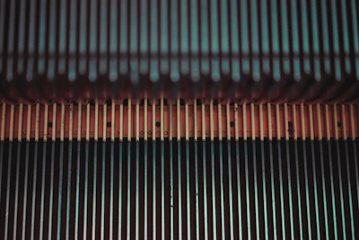 Close-up of elevita's compact motor unit installed at the base of a residential staircase.