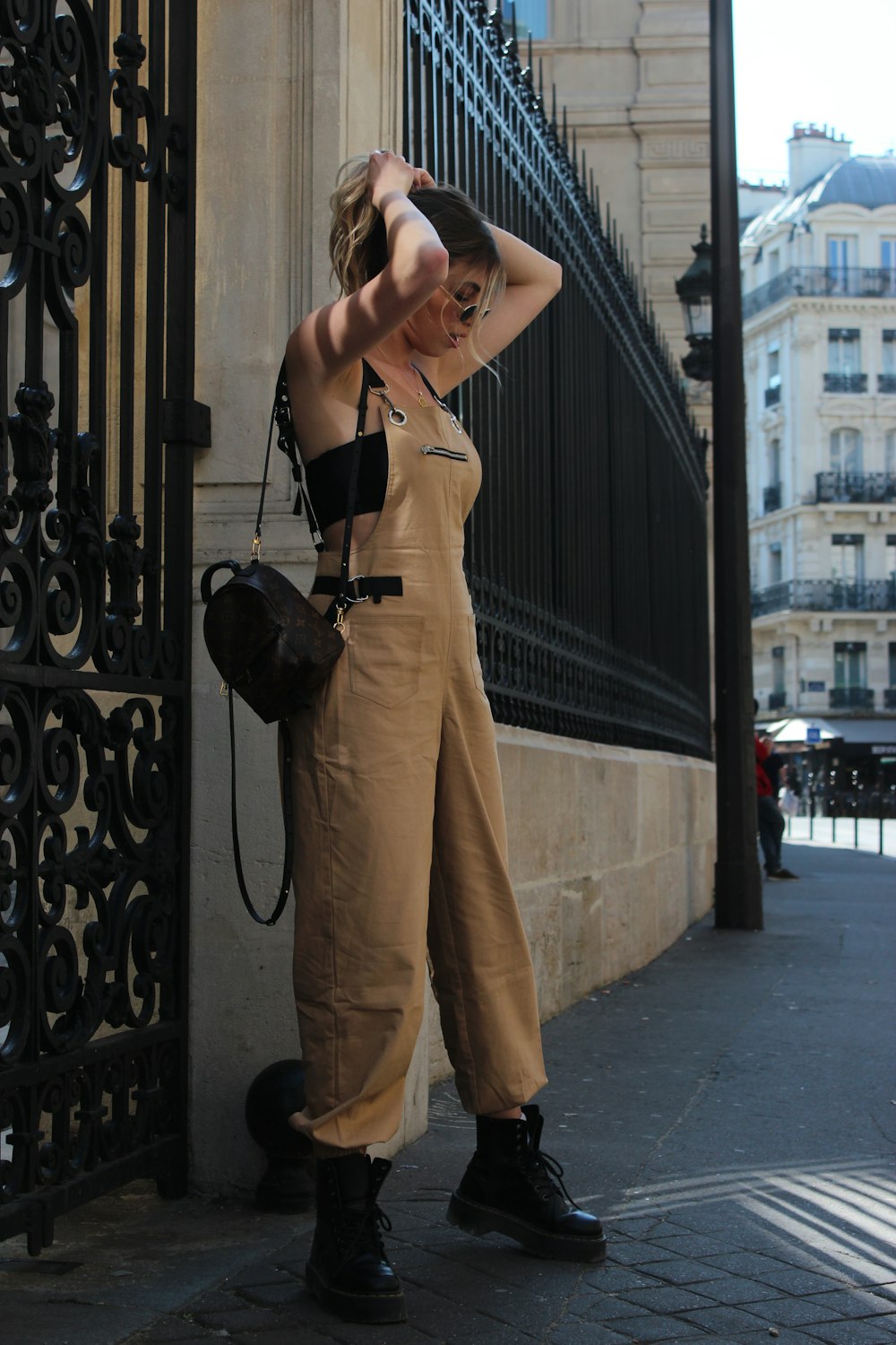 woman holding hair by both hands while standing outdoor