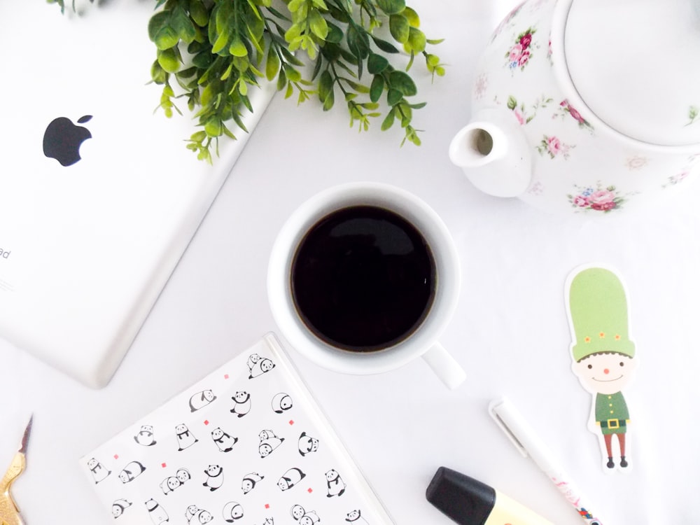 flat lay photography of coffee mug and ipad