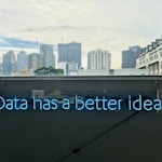 white building with data has a better idea text signage