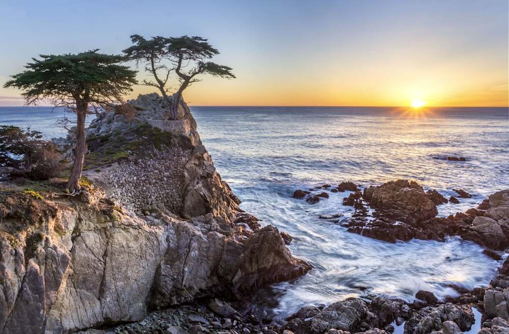 sea waves on rock formation during sunrise