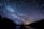silhouette of person standing under starry sky