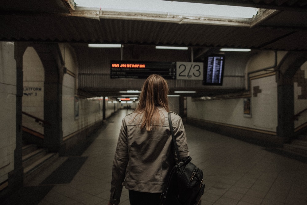 woman standing under tunnel