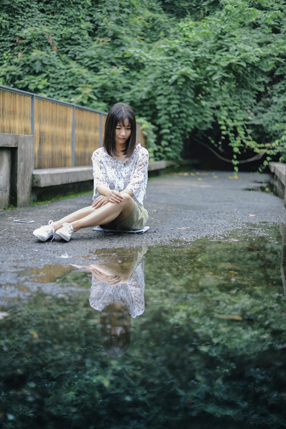 woman sitting gray surface