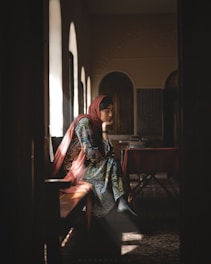 woman sitting on chair while looking down